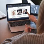 Marketing manager reviewing website content on laptop